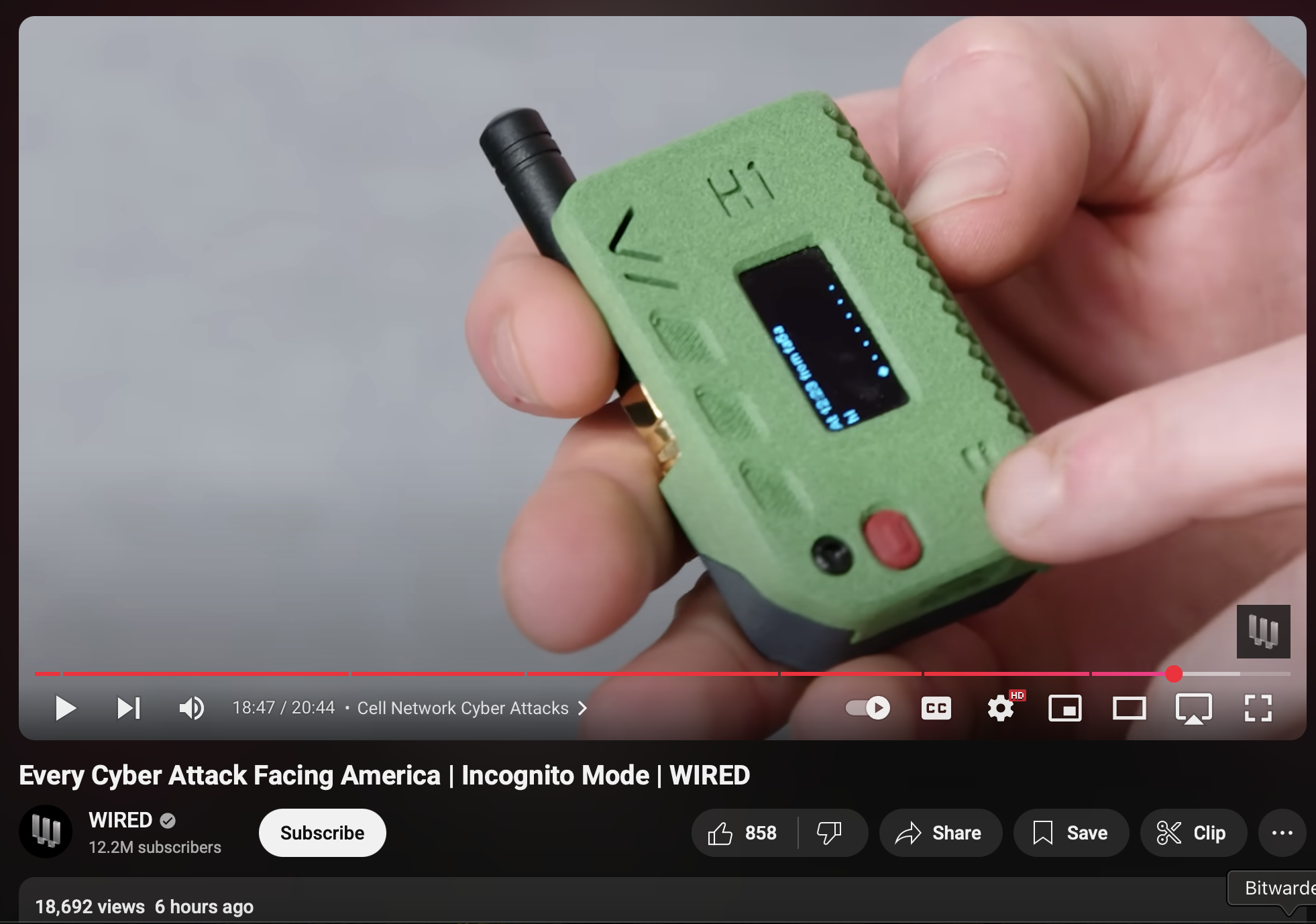 Screenshot of a YouTube video showcasing a meshtastic device in a green 3D printed case. Title of the video is ＂Every Cyber Attack Facing America | Incognito Mode | WIRED＂, various YouTube controls and UI.